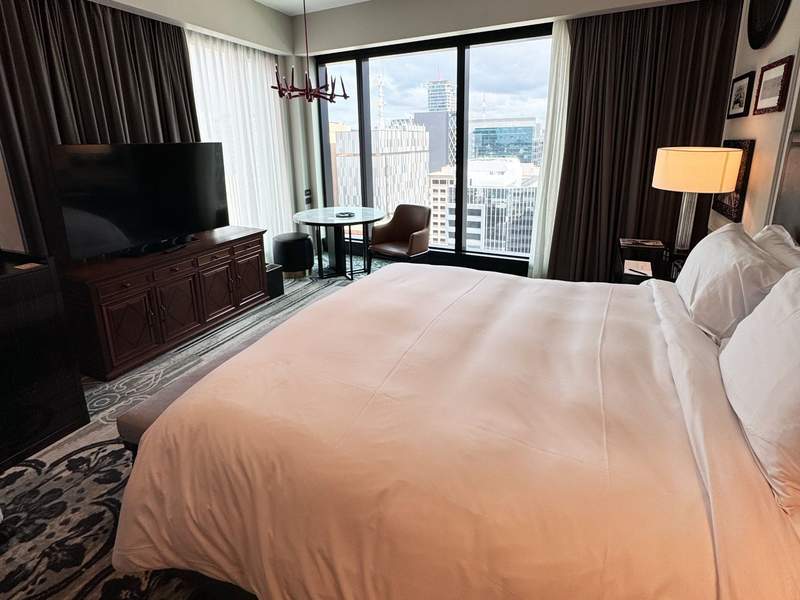 King bed and city views from a corner room at the Sofitel hotel in Adelaide, featured in a South Australia travel guide.