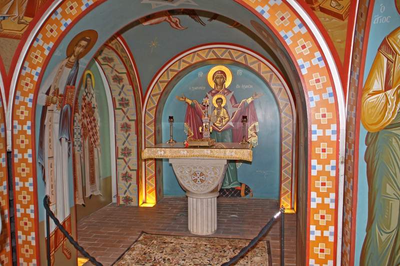 Ornate Byzantine-style religious icons and gold-leaf details inside the chapel of the St. Photios Greek Orthodox National Shrine.