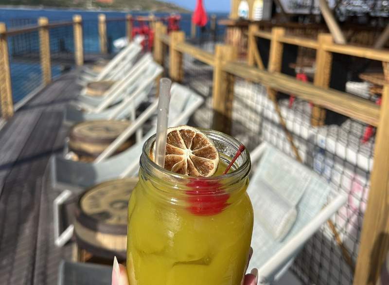 Toasting a vibrant colored cocktail at Saba Rock is an amazing way to enjoy the sunset