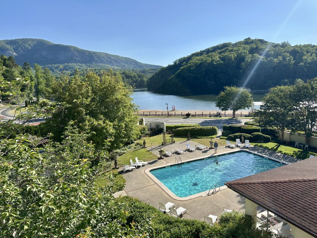 Outdoor swimming pool at Lake Lure Inn and Spa with the lake in the background, surrounded by Western North Carolina mountains