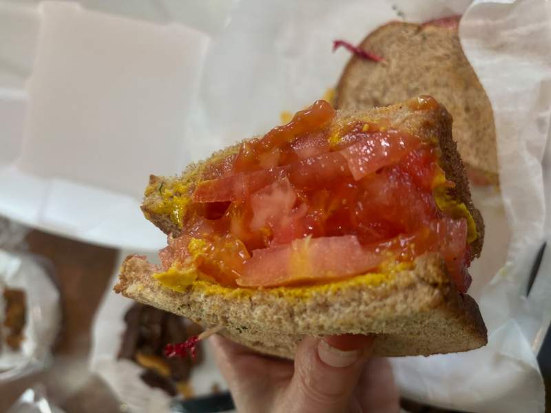 A classic tomato sandwich, but with mustard and whole wheat bread
