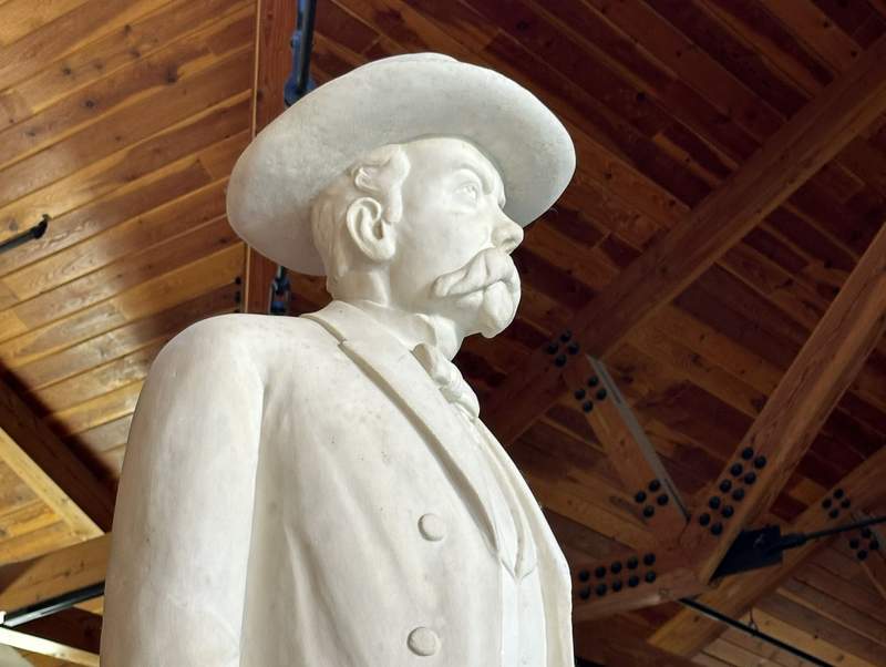 A white statue of Jack Daniel.