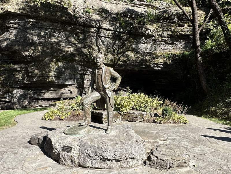 A statue near a cave.