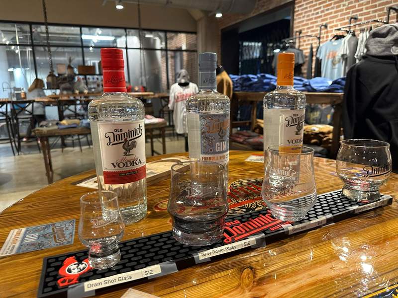 Some bottles of spirits and some glasses in front of the bottles..