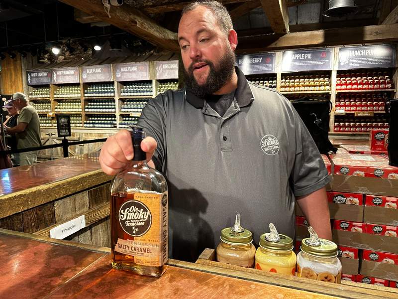 A man with a bottle of Ole Smoky in his hand. 