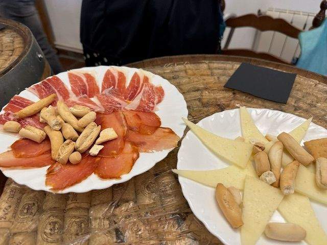 Enjoy a glass of wine with local cheeses and ham.