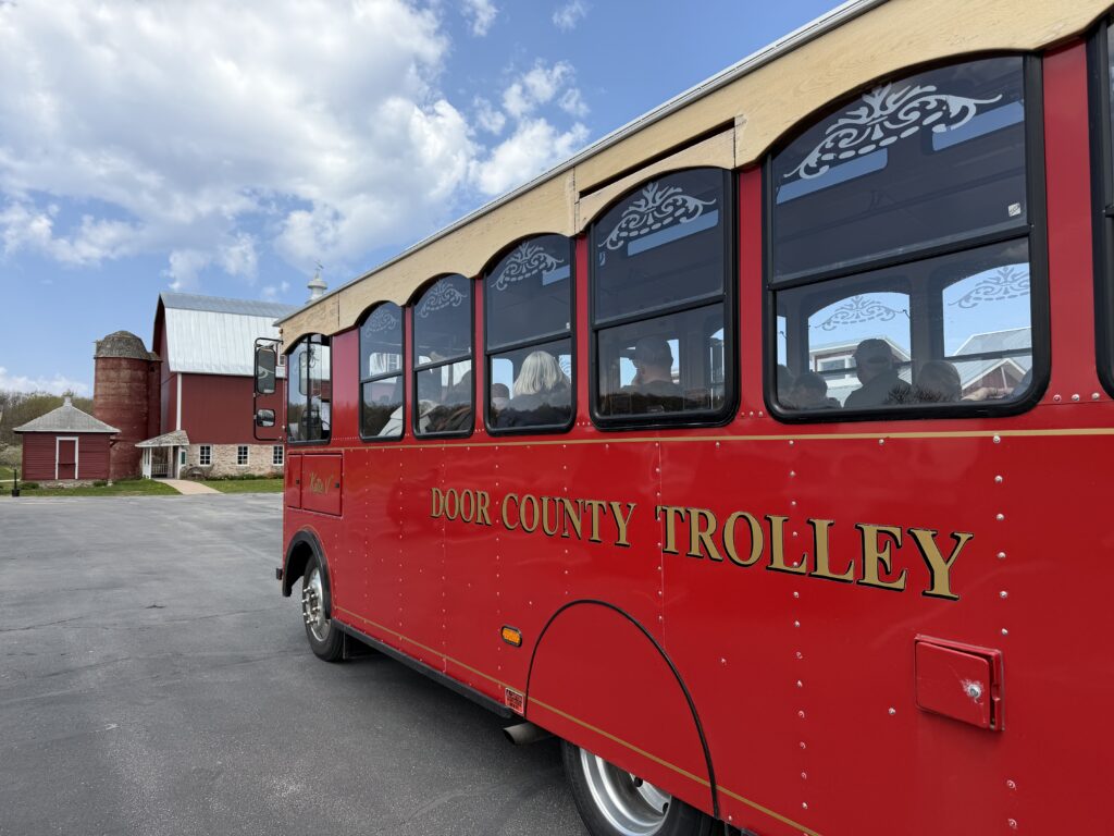 Red Door County trolley in front of red barn