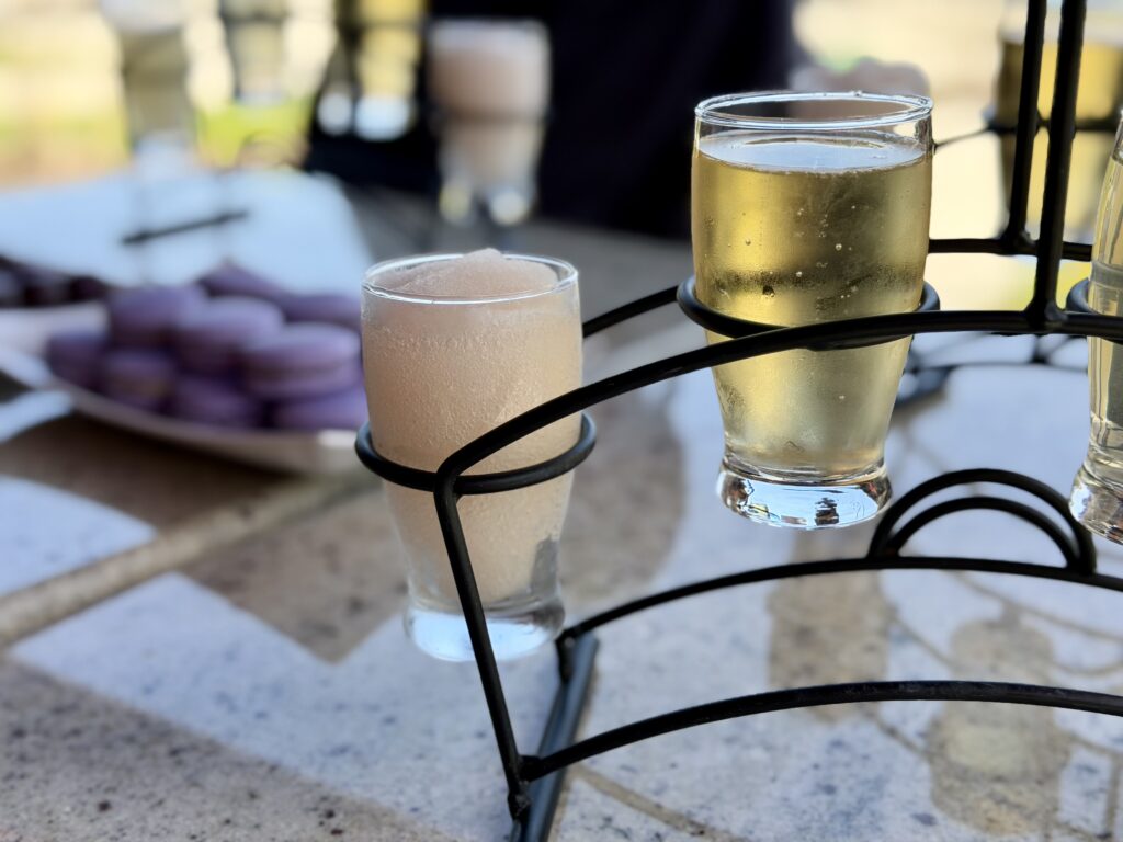 Two lavender-infused drinks in front of purple macarons at Fragrant Isle lavender farm