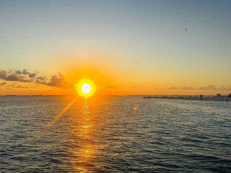 Sunset over the Caribbean Sea during a catamaran cruise to Isla Mujeres near Sandos Cancun.