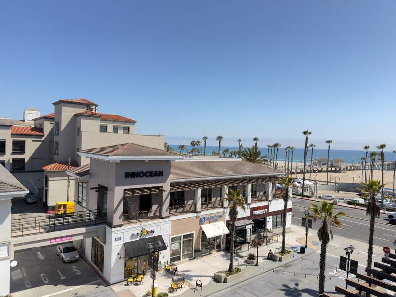 View of PCH palm trees and the ocean from the room at the Kimpton Shorebreak Resort.
