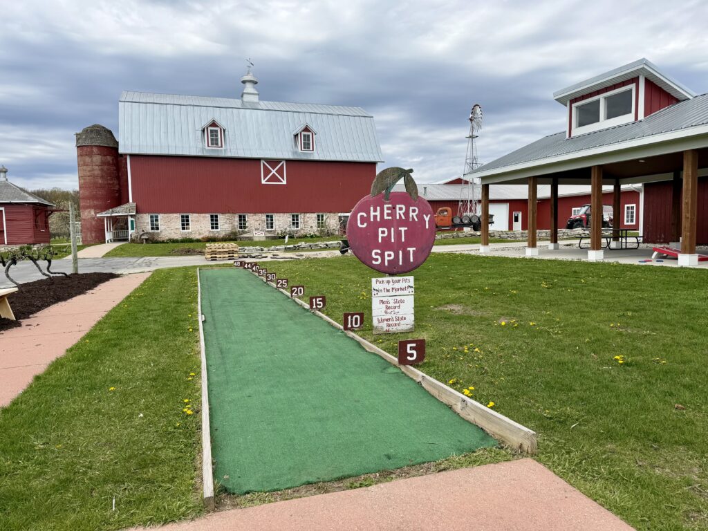 Lautenbach Orchard cherry pit spit alley with red barn in background.