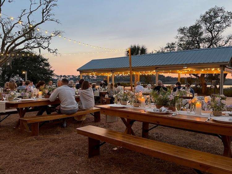 Guests gather at decorated tables under lights at the Mingo Point Welcome Party