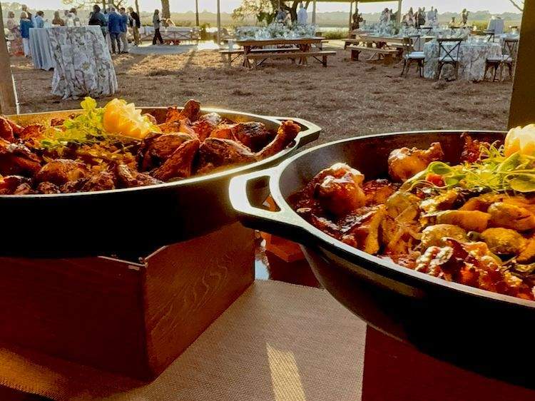Two serving dishes of entrees waiting while guests mingle