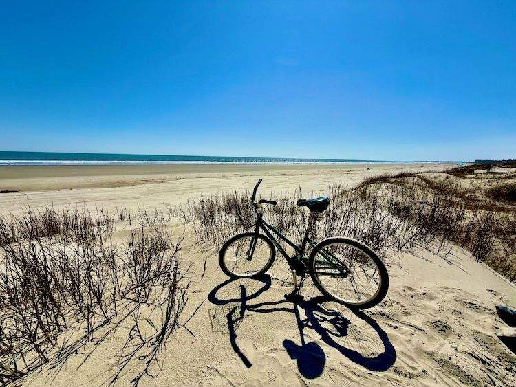 Bike on the beach with open sand and ocean in the background
