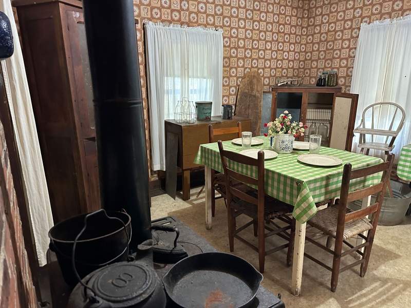 Inside the kitchen of the Elvis Presley childhood home with a table and chairs.