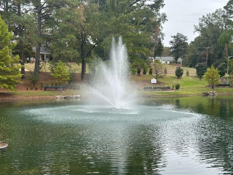 A peaceful pond and fountain at the Elvis Presley Birthplace park.