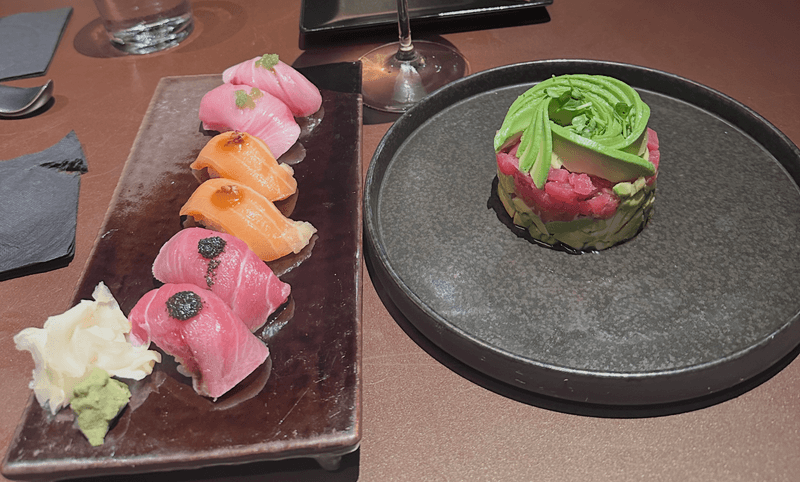Chefs choice nigiri platter with tuna yellowtail and salmon next to a tuna avocado appetizer at ShinSen Aruba