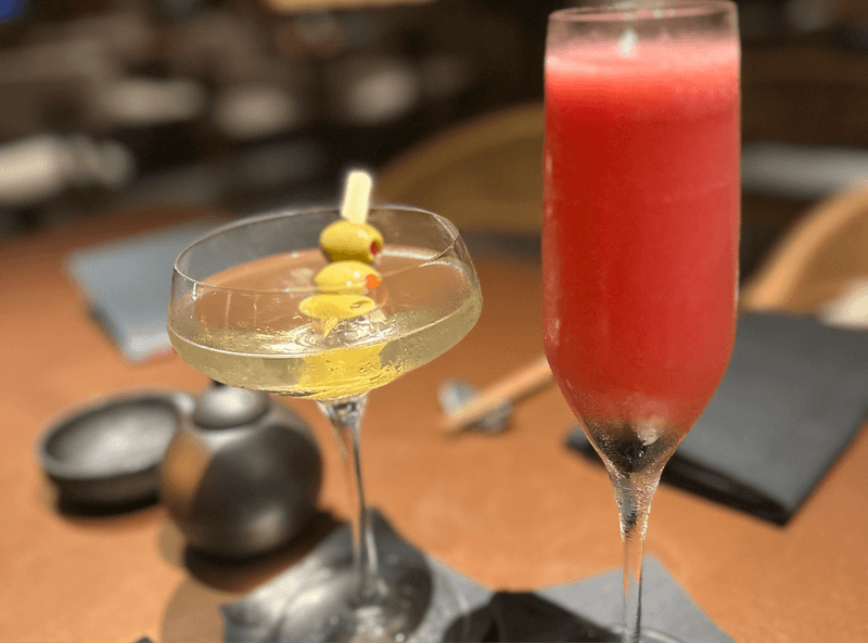 Sake martini with olives and a Berry Japanese 75 cocktail in a champagne flute at ShinSen Aruba