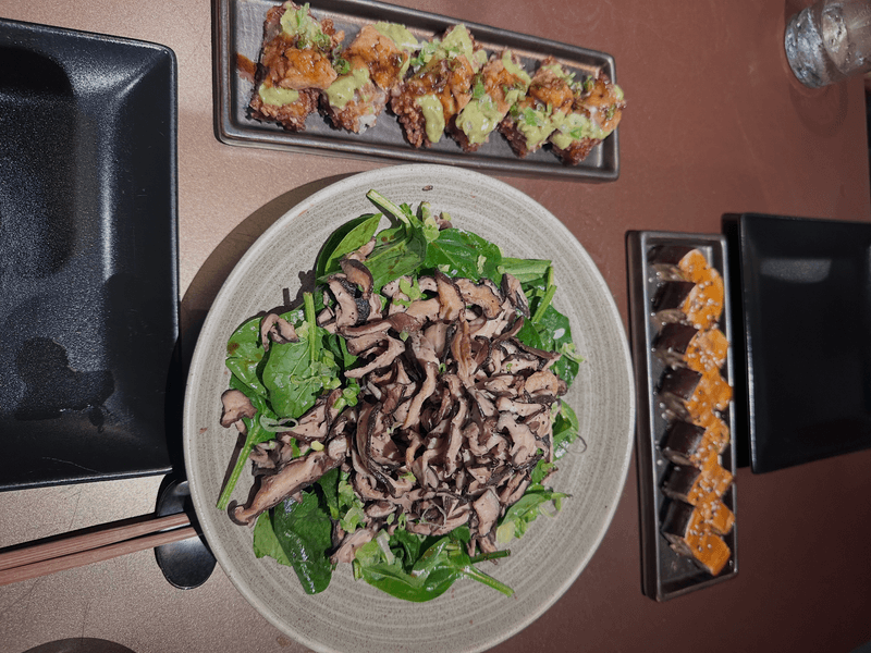Overhead view of warm mushroom salad tuna crispy rice and miso eggplant starters at ShinSen Aruba