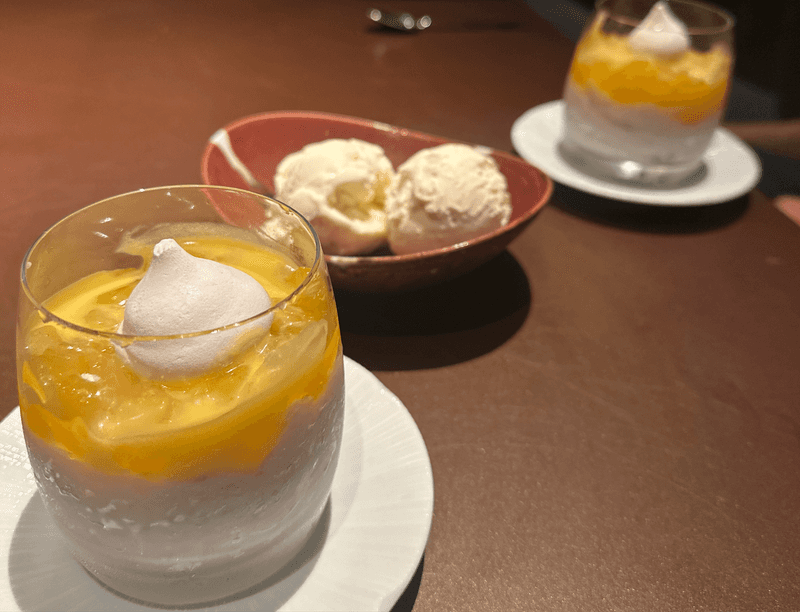 Coconut rice and mango dessert with vanilla ice cream served in a glass at ShinSen Aruba