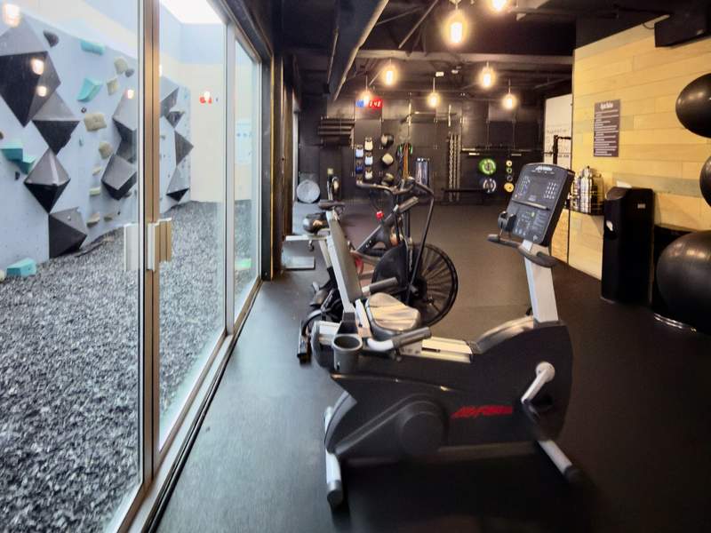 Stationary bikes and climbing wall in the gym at the Kimpton Shorebreak Resort. 