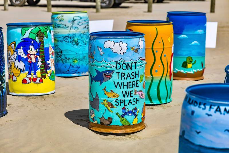 Colorful beach theme decorated trash cans.