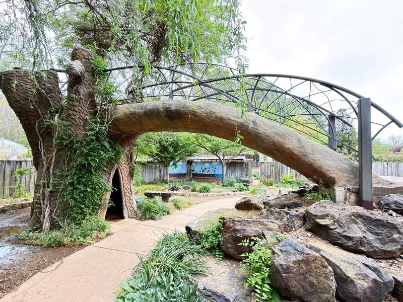 Scenic walking paths and vibrant seasonal flower beds inside the 12-acre Botanical Garden of the Ozarks in Fayetteville, Arkansas.