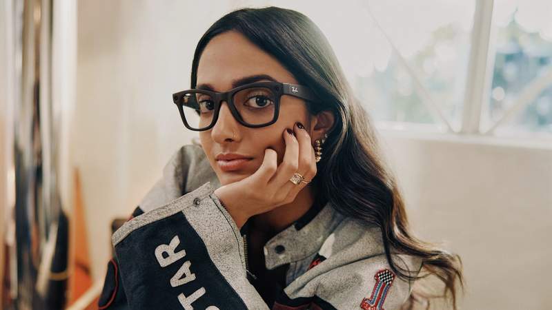 Brunette woman with her hand under her chin, wearing Ray-Ban Meta AI Glasses.