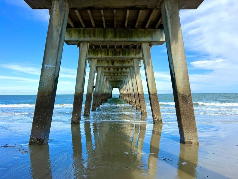 A look beneath a long pier at Tybee Island