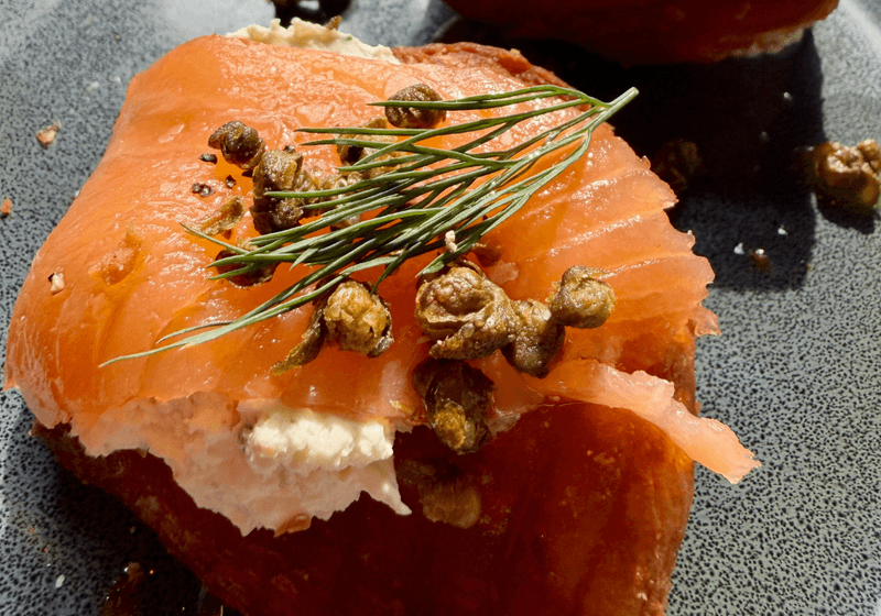 Smoked salmon on toasted brioche with cream cheese, fried capers, and fresh dill at SoHo Standard in Birmingham, Alabama