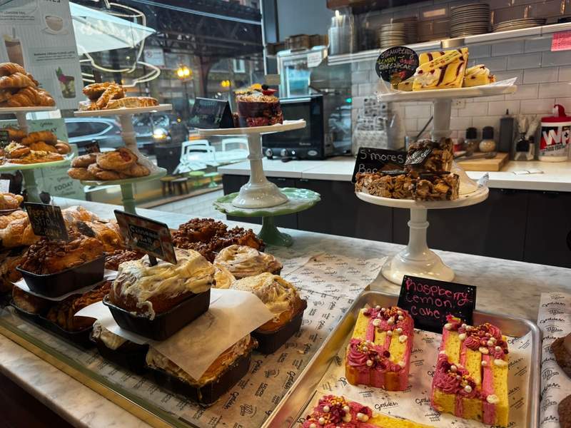 Bakery case inside Goddess and the Baker, displayed in the most adorable and fun café setting, filled with fresh pastries and colorful baked treats.