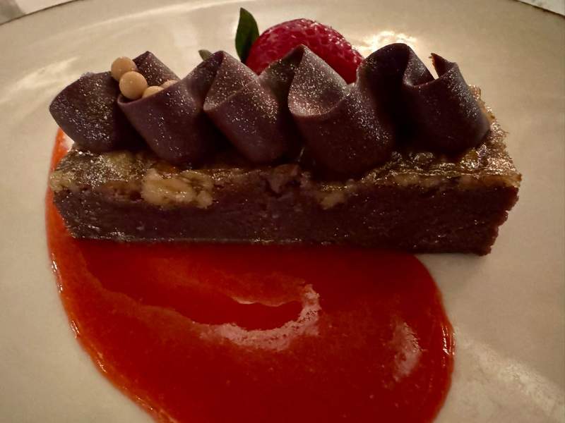 Close-up of the famous Palmer House brownie at the Palmer House Hilton, a rich, fudgy chocolate dessert topped with a glossy walnut and apricot glaze, known as a Chicago classic.