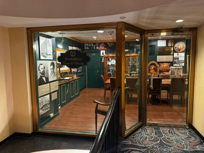 View through a window into the history museum at the Palmer House Hilton, showing curated exhibits that highlight the hotel’s rich heritage and long-standing place in Chicago history.