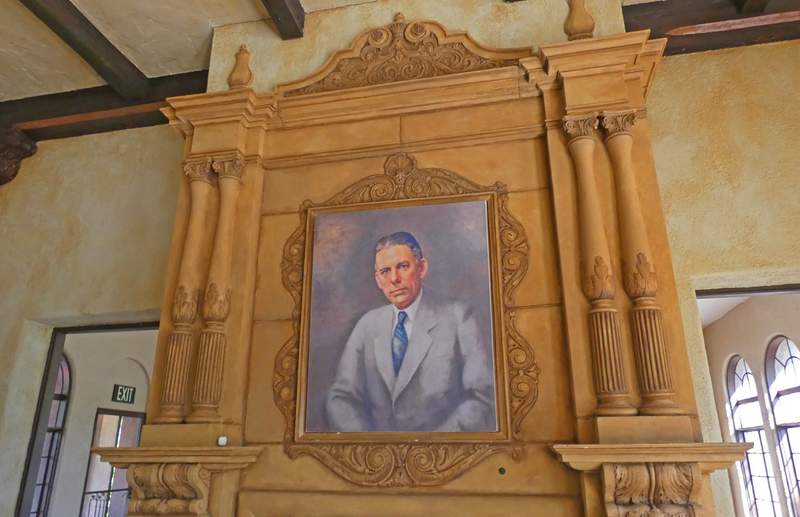 A portrait of a man in the middle of an antique mantle.