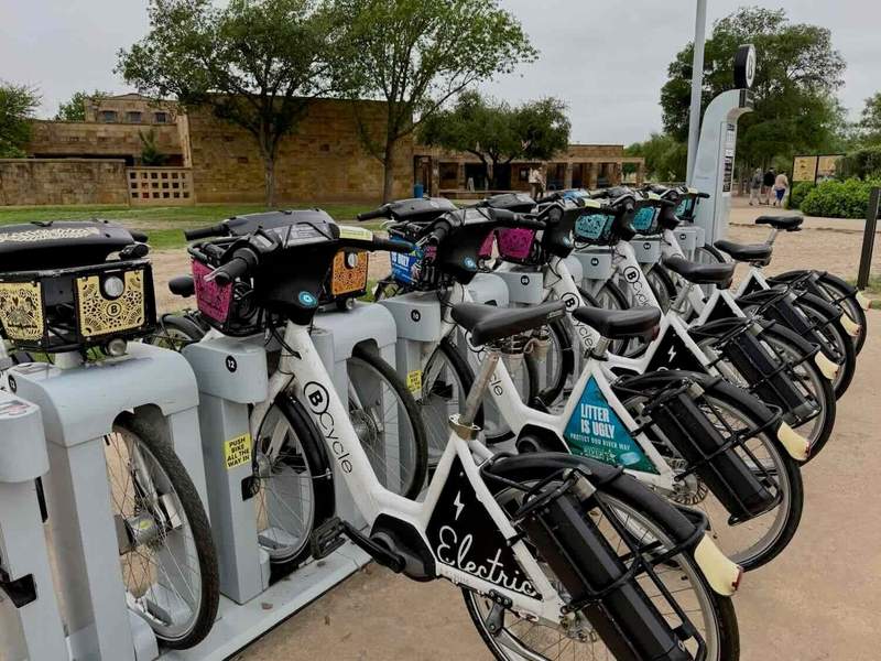 BCycle e-bikes in racks in front of Mission San José.