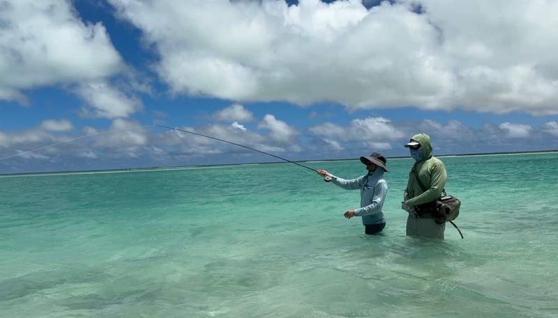 Two men fly fishing salt flats