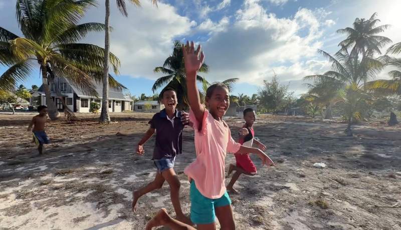 children running and waving