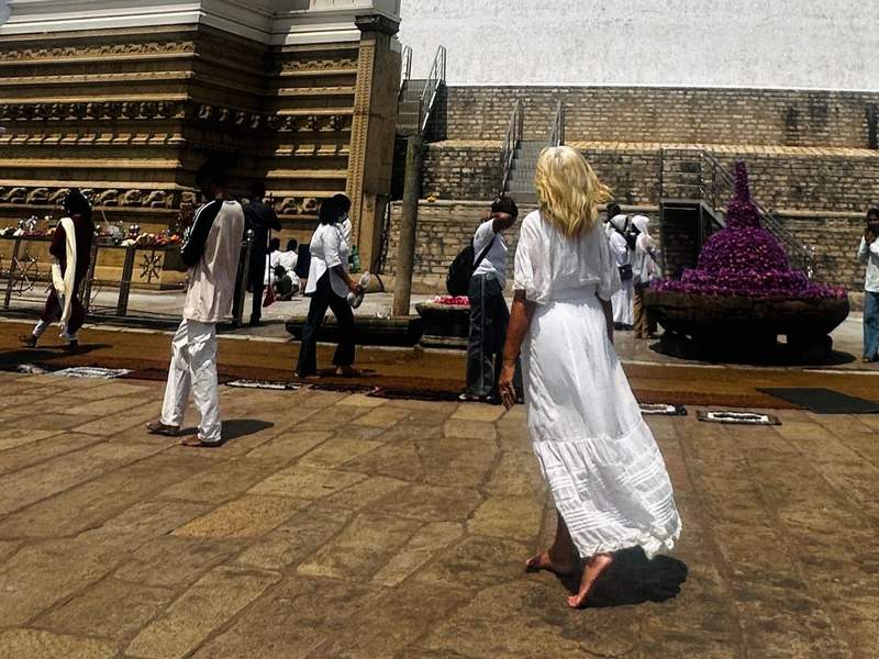 woman standing in front of buddhist stupa sri lanka.