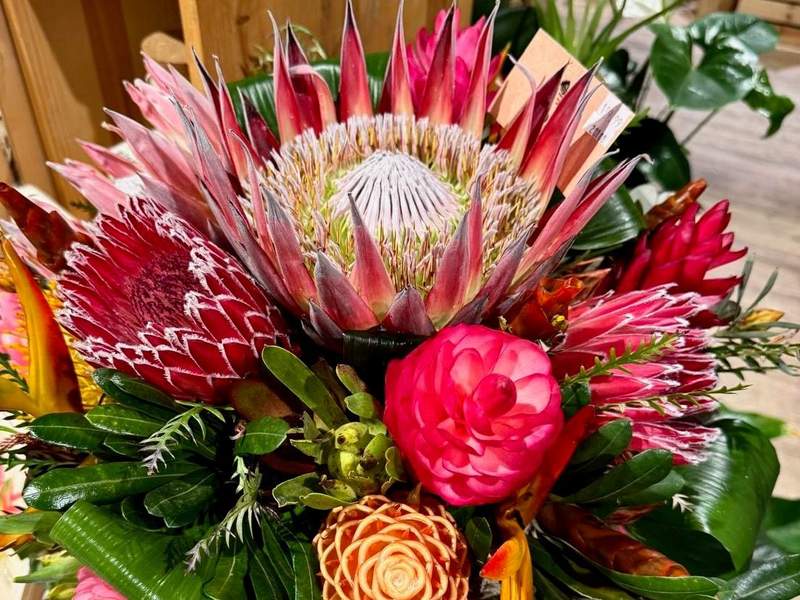 Gorgeous arrangement with white, red and pink tropical flowers.