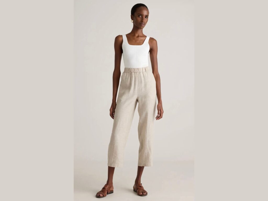 Black woman wearing white tank top and Quince crop linen pants