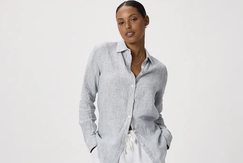 Black woman wearing a light colored linen shirt