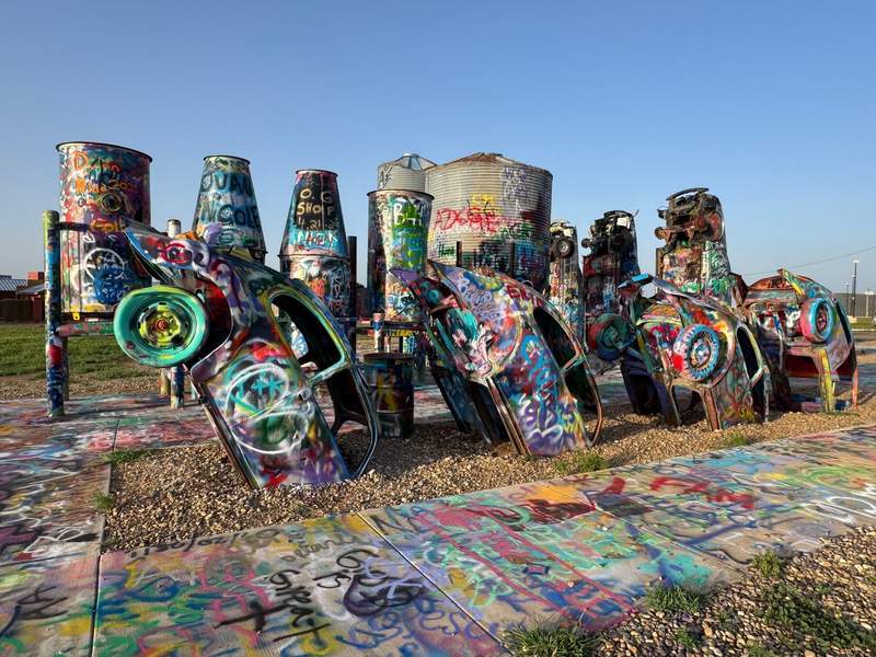 Painted cars stuck in the ground at a Texas roadside attraction