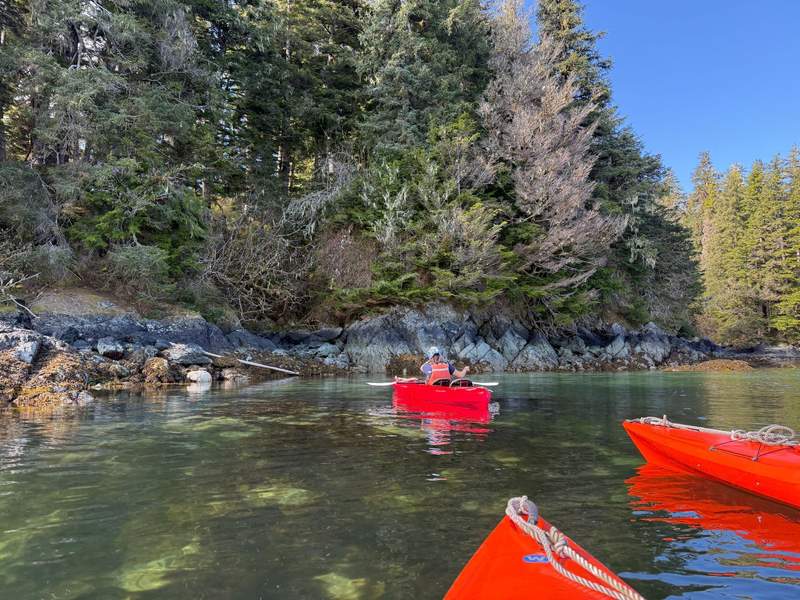 Three kayaks in bay