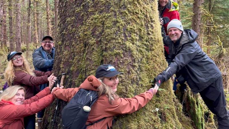 People hugging a tree