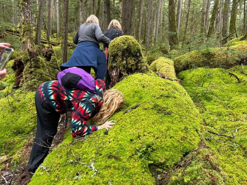 Woman with her face in moss