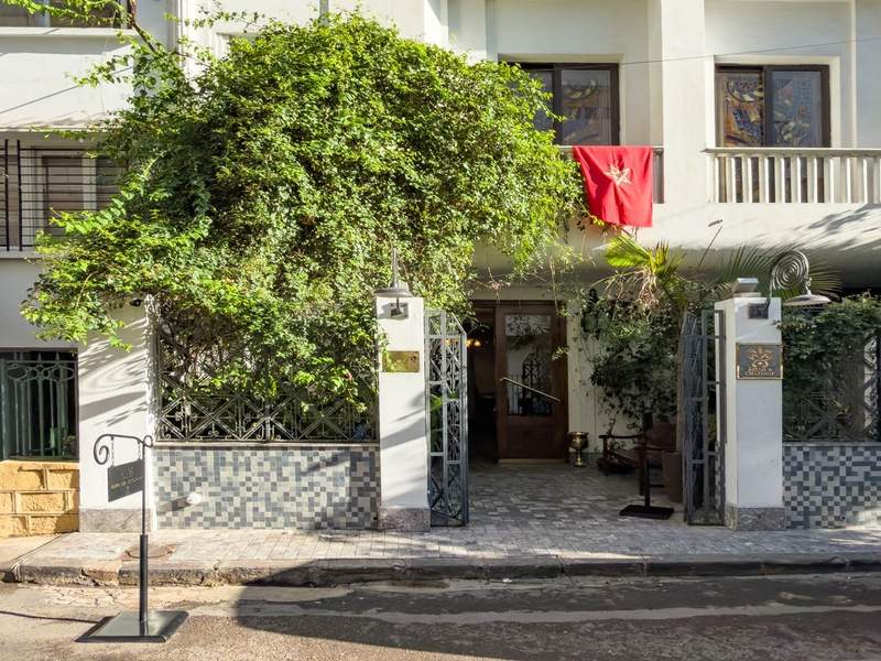 A hotel building with a red flag from the front
