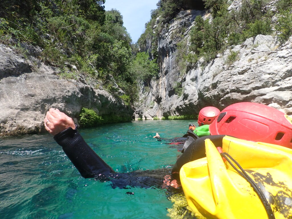 POV of two backstroking canyoneers in Aragon Spain from the river.