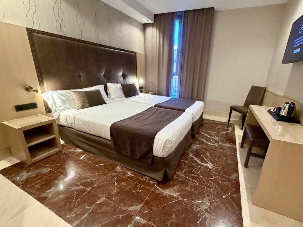 Comfortable double room with minimal furnishings at the Hotel Pedro I in Huesca Spain