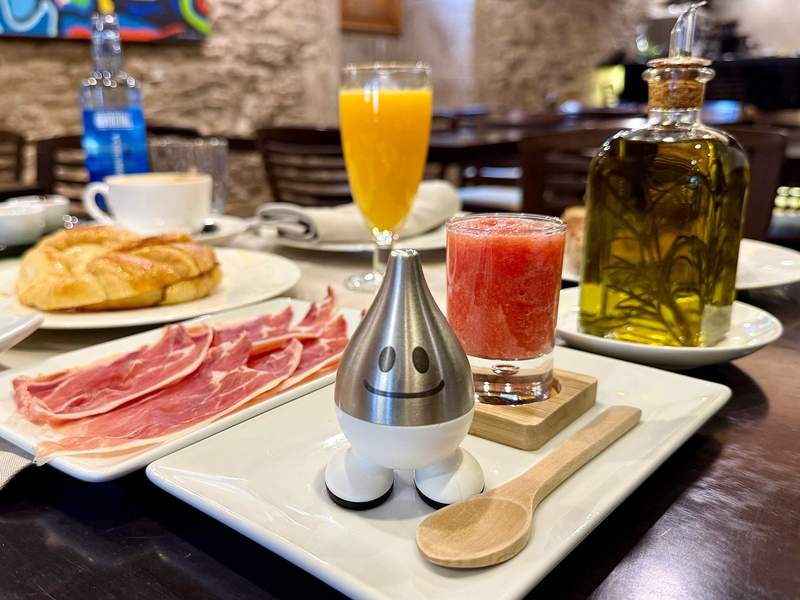 An amazing breakfast spread of fresh juices, cured meats, pastries and loveable salt and pepper shakers.