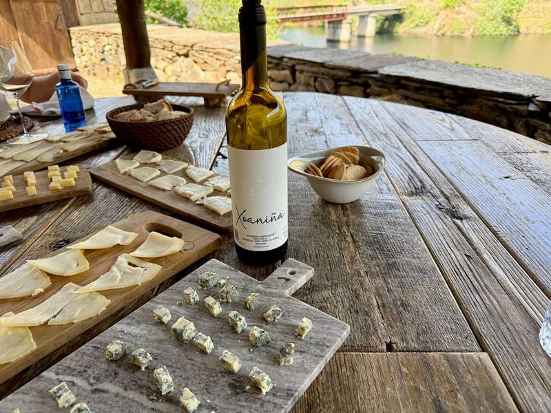 Cheese boards and wine with a view of the Minho river valley behind.